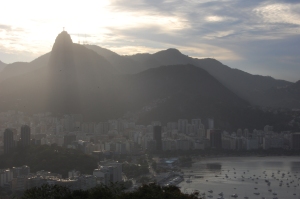the sun starts to set behind Christ the Redeemer