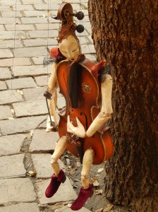 a marionette resting between shows in the square