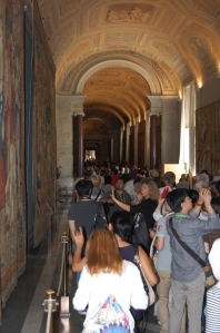 crowds file past halls of tapestries (Don)