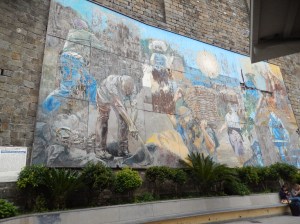 mural celebrating heroic grape-pickers and fishermen of the region