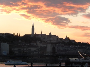 sun set behind the Royal Palace, reflecting in the Danube River
