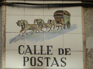 this street sign shows the post coach heading for that first post office in Puerta del Sol