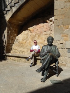 Julio poses with statue of Spanish director Pablo Garcia Albano; his movie La Vaquilla, a comedy of the Spanish Civil War, was filmed in this town and used several of the locals